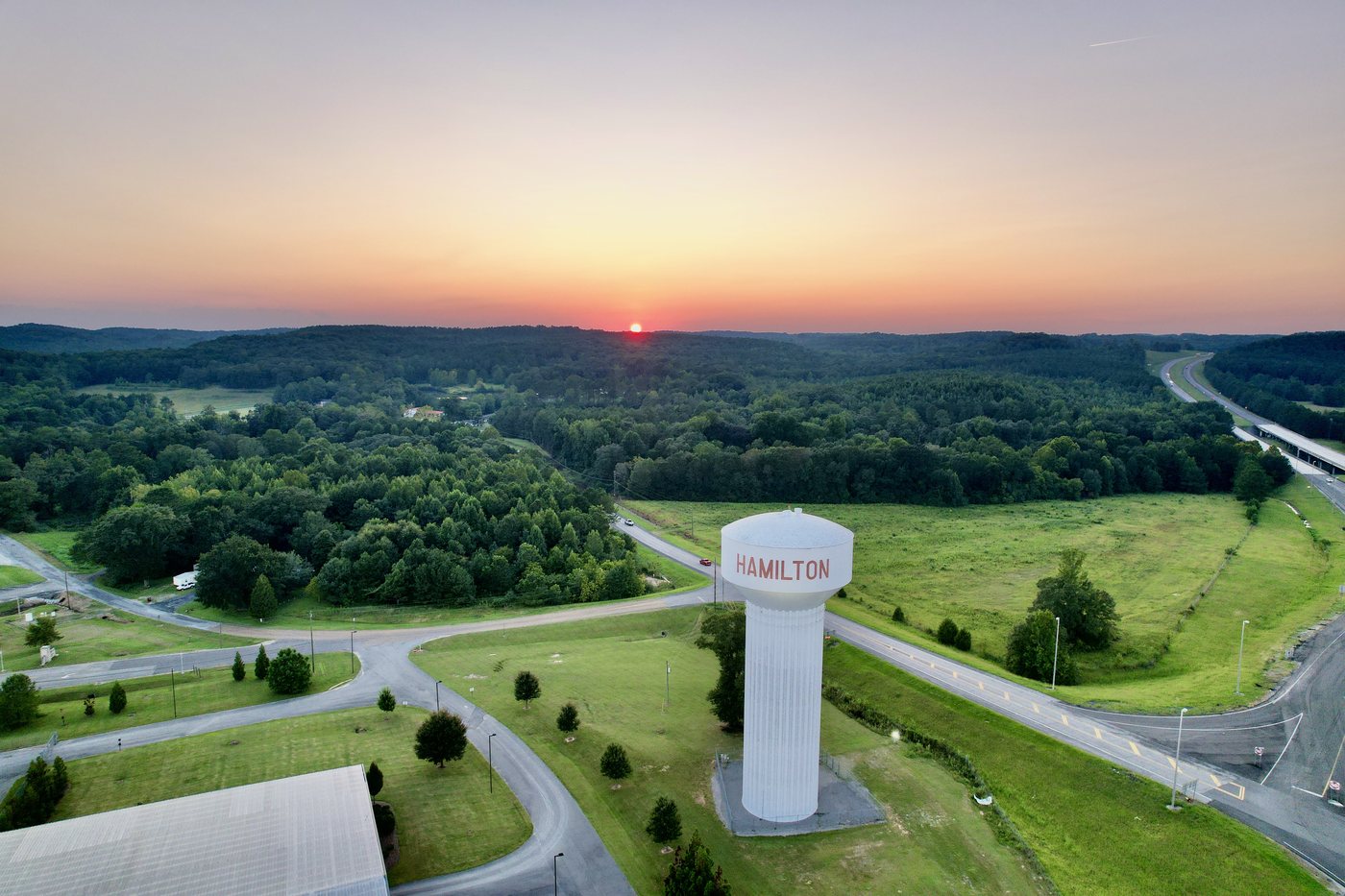 Aerial sunset view over Hamilton water tower and surrounding roads