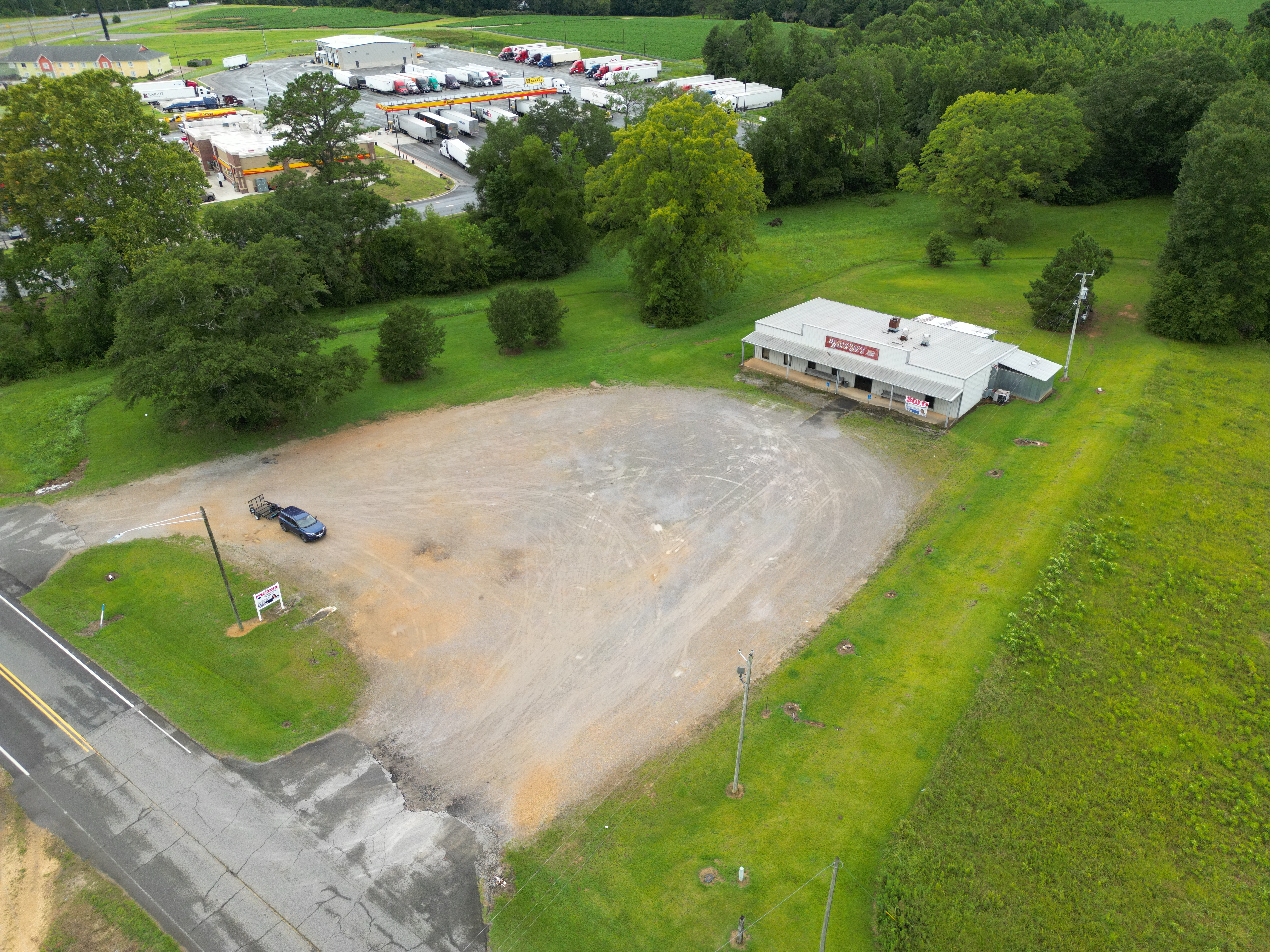 Aerial property photo showing land layout, access, and surrounding terrain