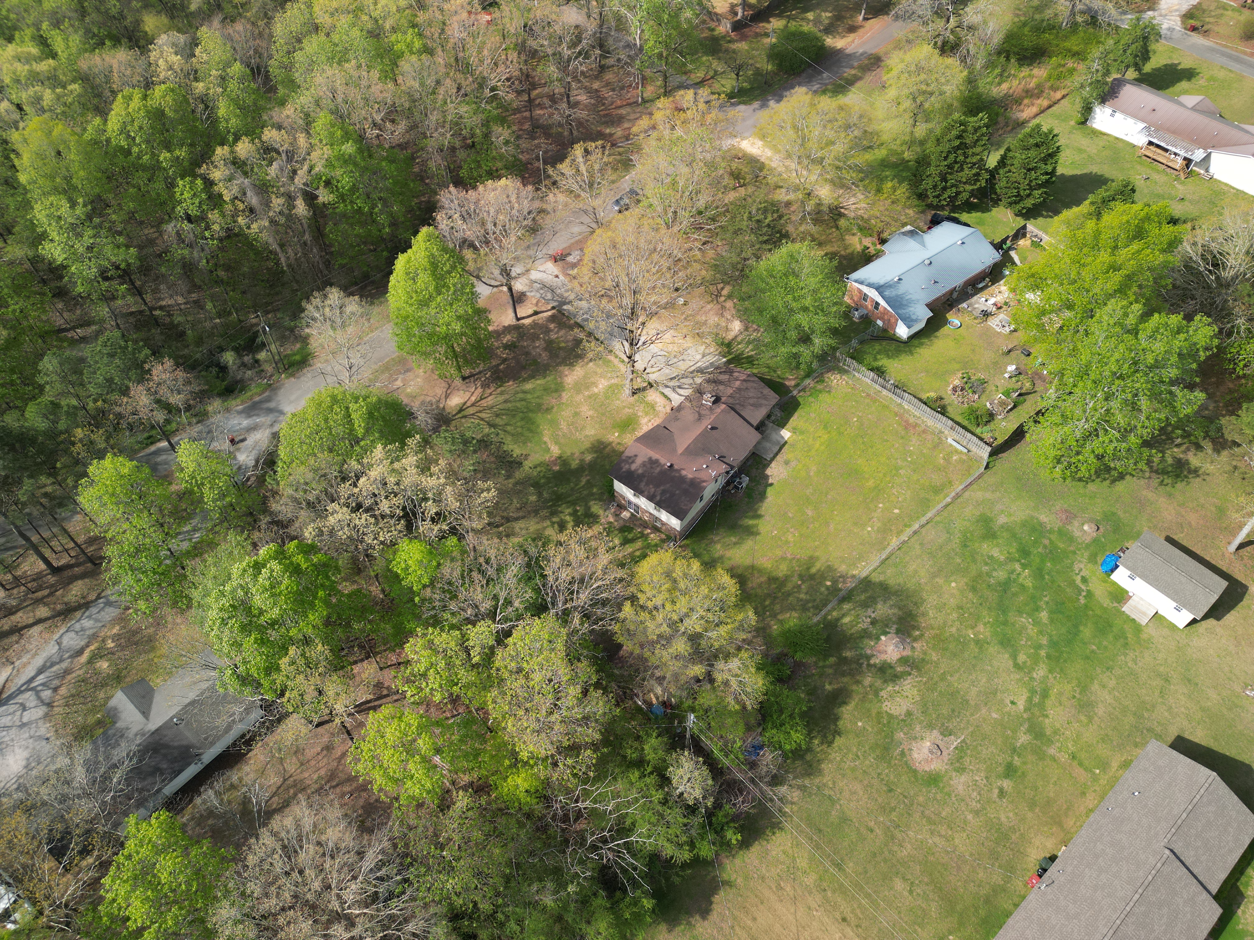 Drone photo of acreage and nearby tree lines for property documentation